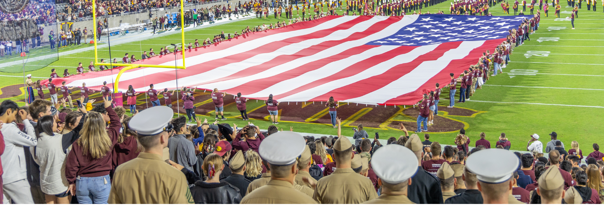 Crowd at a football game full of primarily military members